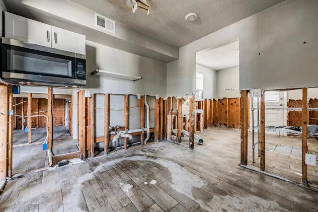 a view of a room with gym equipment and a large window