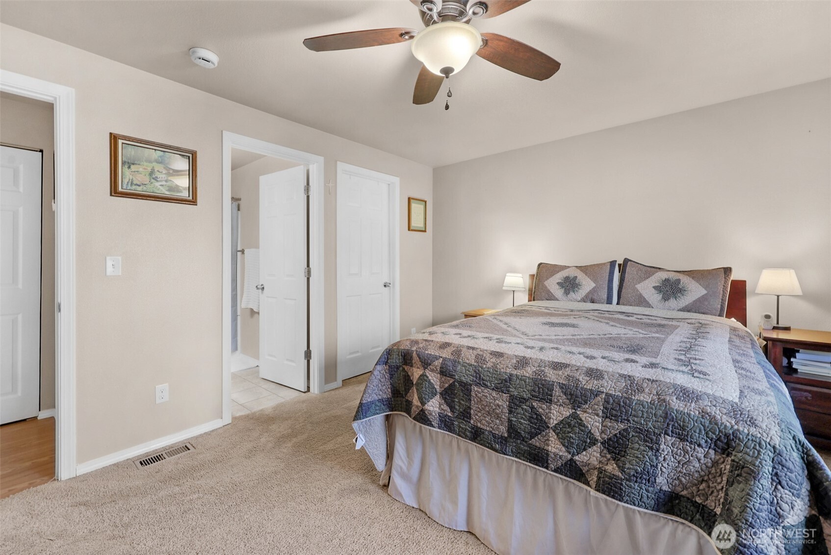 402 Haines Street Sedro-Woolley, WA 98284 - Photo 14 of 24 a bedroom with a bed and a chandelier