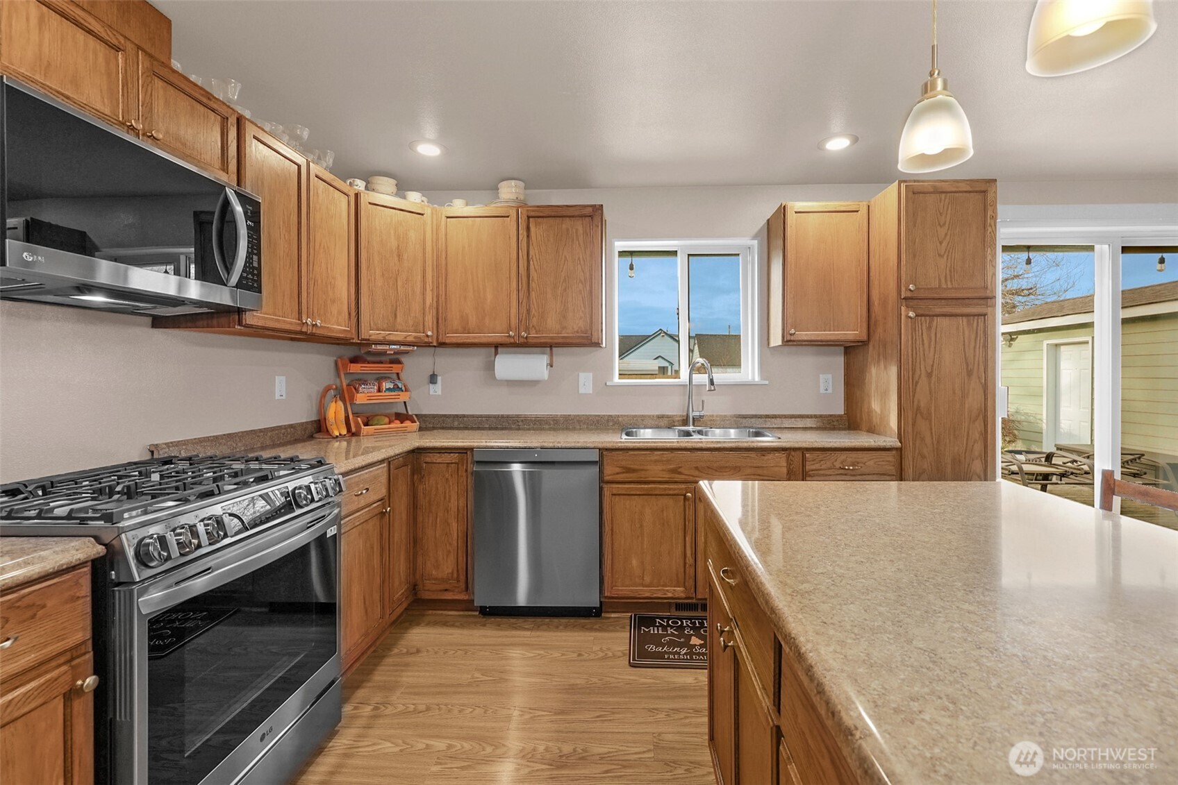 402 Haines Street Sedro-Woolley, WA 98284 - Photo 5 of 24 a kitchen with stainless steel appliances granite countertop a stove a sink and a microwave