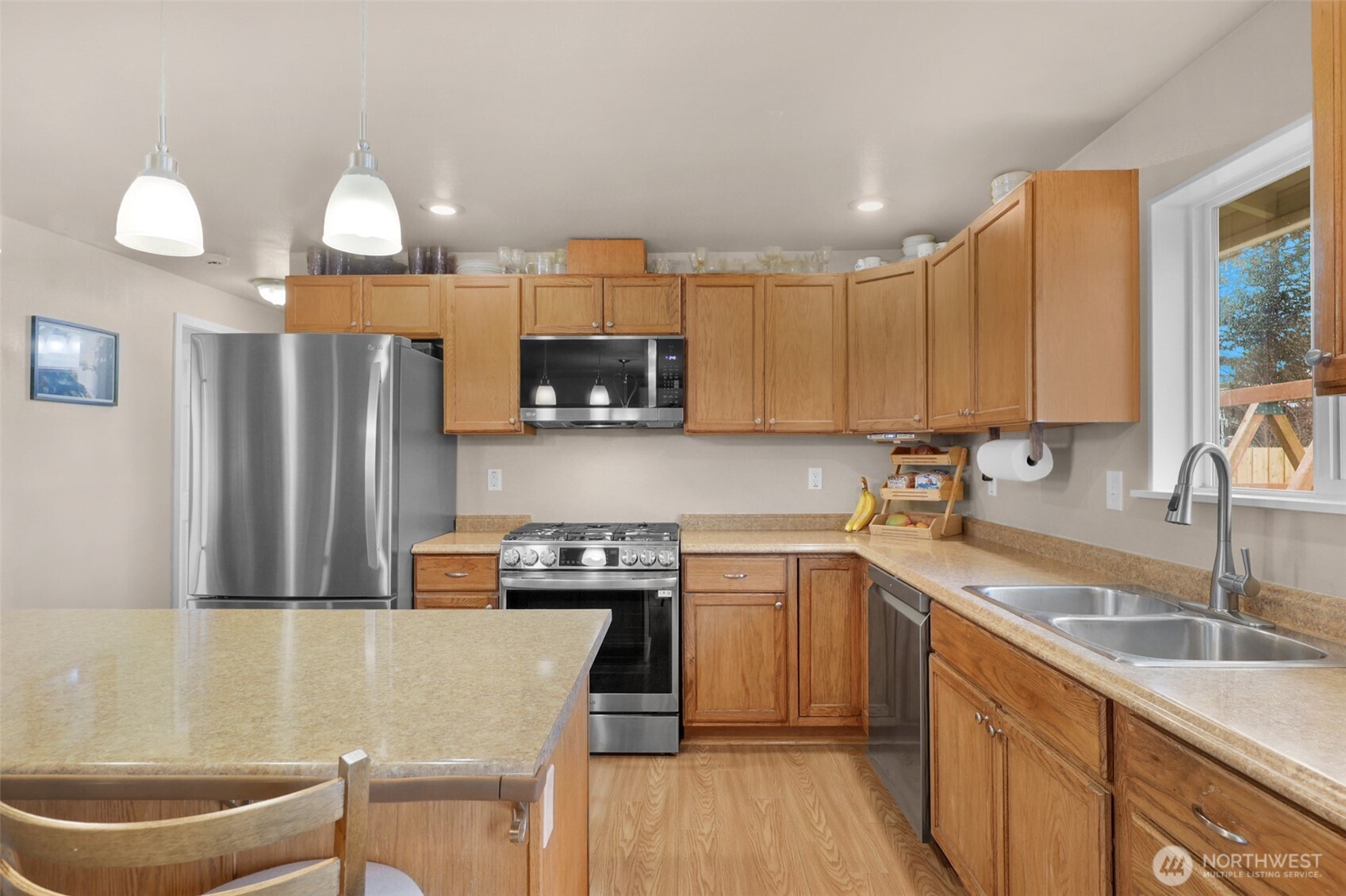 402 Haines Street Sedro-Woolley, WA 98284 - Photo 9 of 24 a kitchen with stainless steel appliances a sink a stove a refrigerator cabinets and a dining table