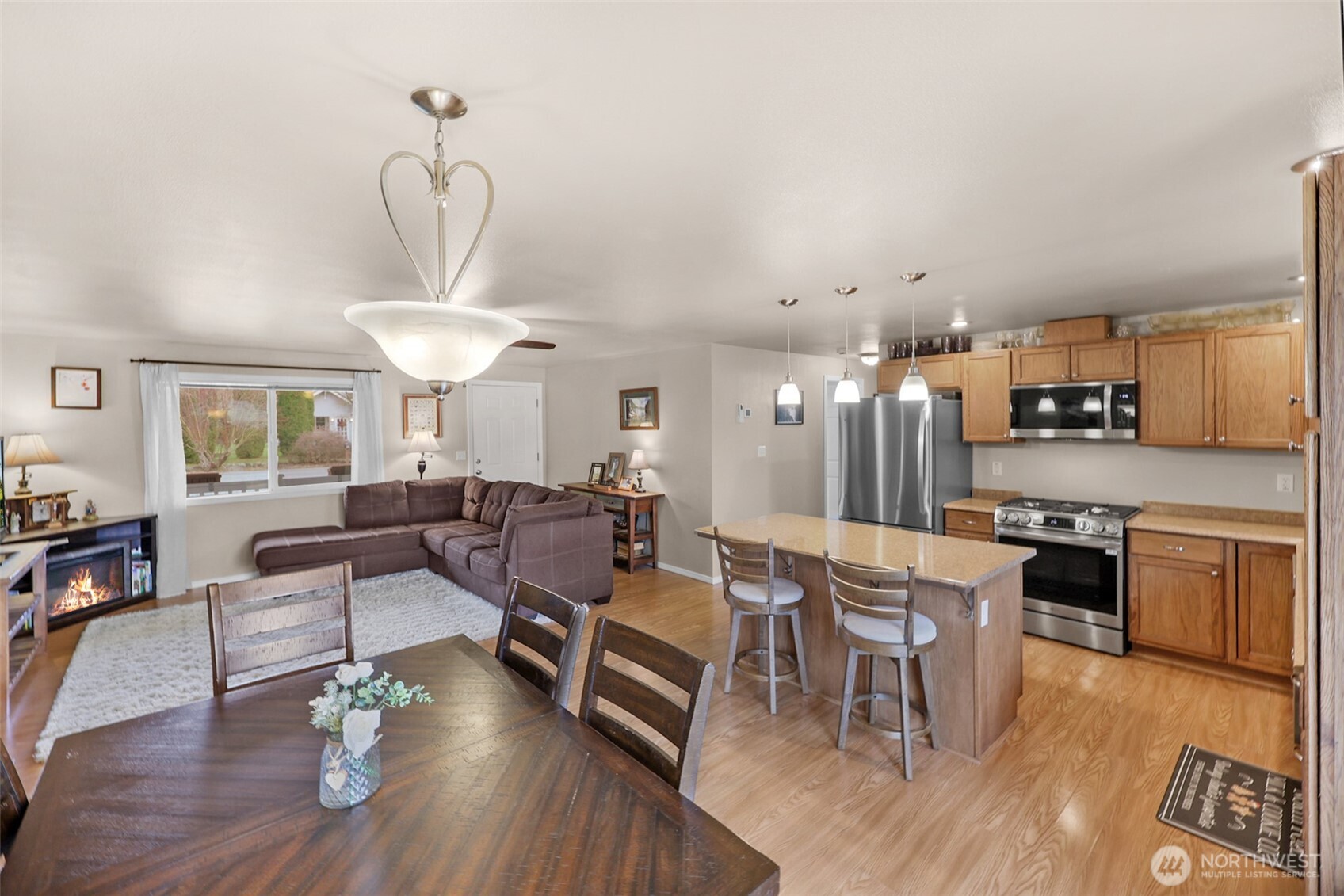 402 Haines Street Sedro-Woolley, WA 98284 - Photo 10 of 24 a living room with stainless steel appliances kitchen island a table and chairs in it