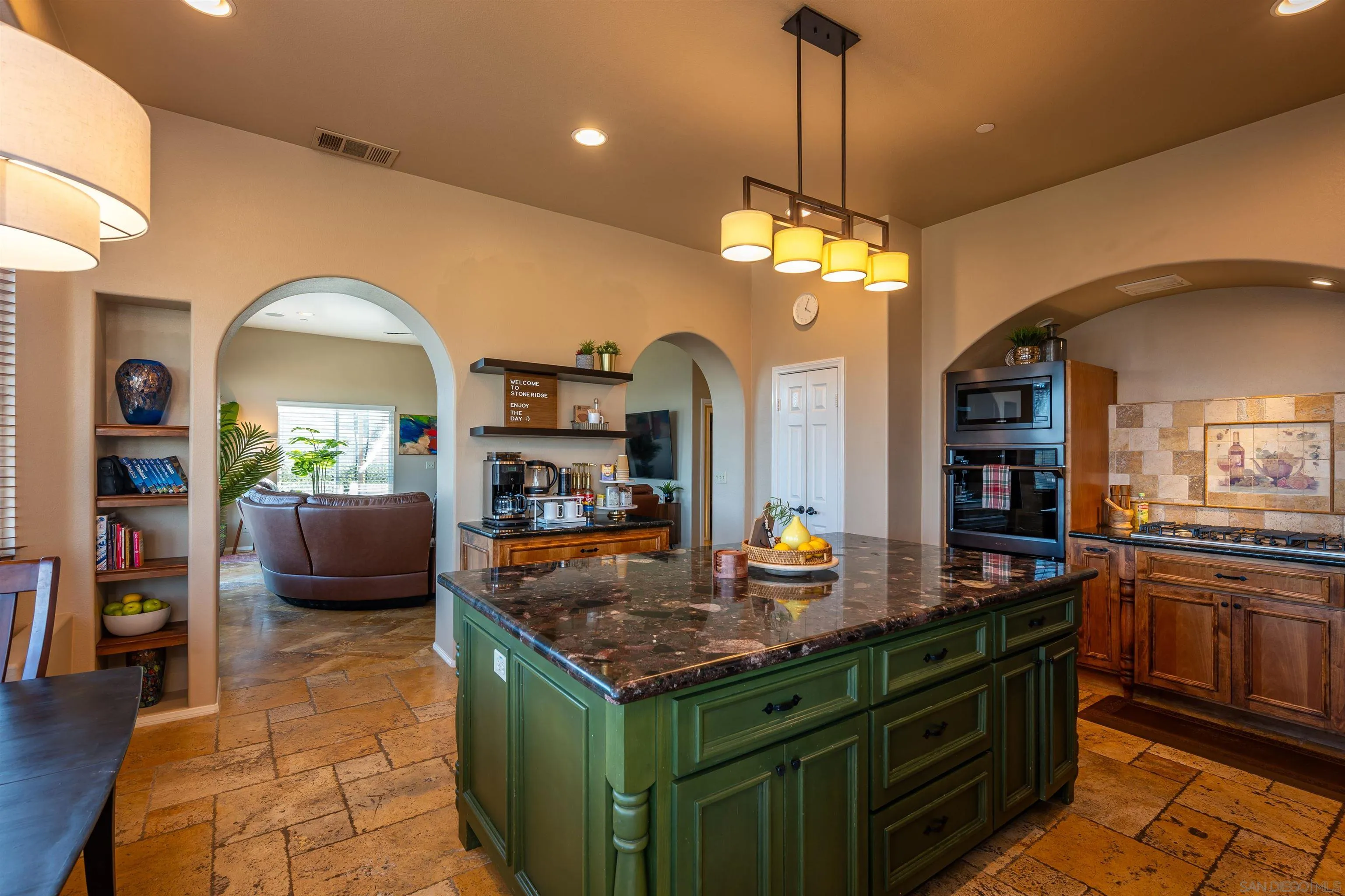 1152 Stoneridge Road El Cajon, CA 92021 - Photo 30 of 71 a kitchen with a stove a sink a kitchen island a stove and a dining table