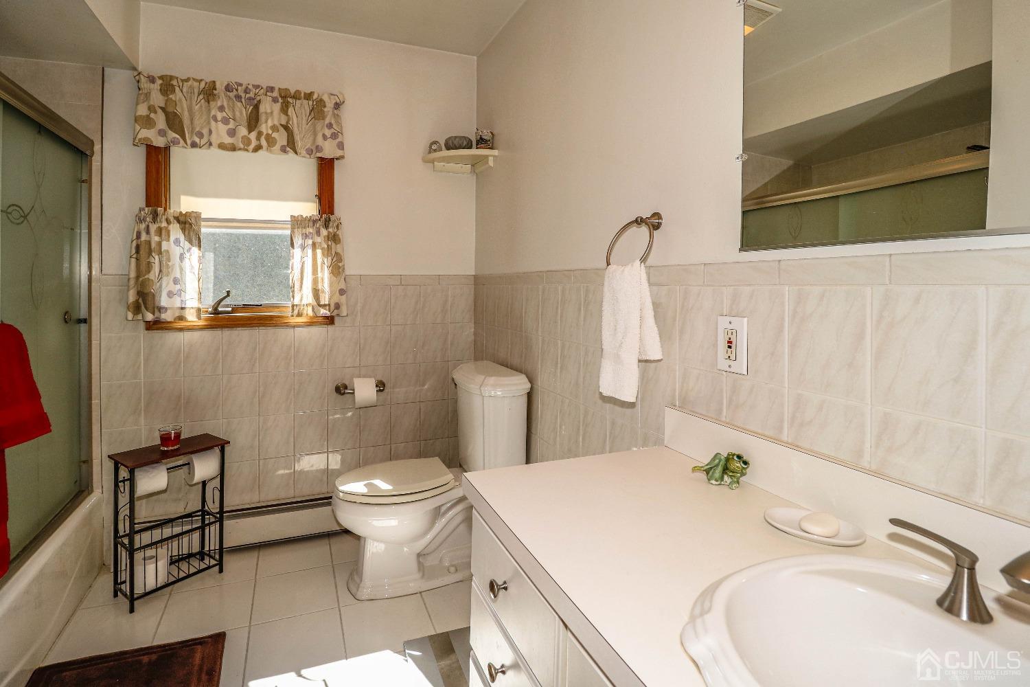 67 Normandy Road Colonia, NJ 07067 - Photo 18 of 28 The primary bath has ceramic tiled flooring, oversized vanity sink and tub/shower combination.