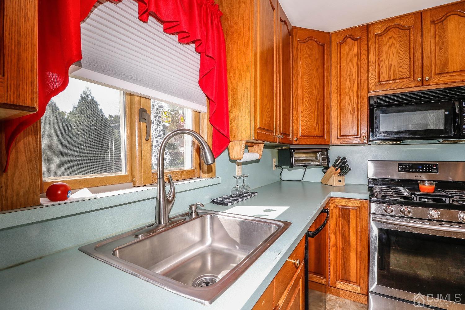 67 Normandy Road Colonia, NJ 07067 - Photo 8 of 28 Lots of natural light through the double andersen windows above double stainless steel sink.
