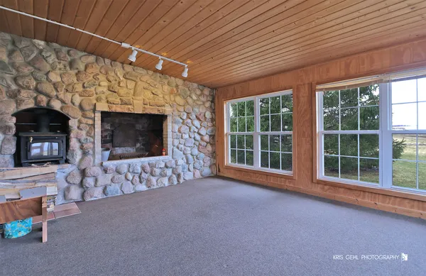 a view of empty room with a fireplace