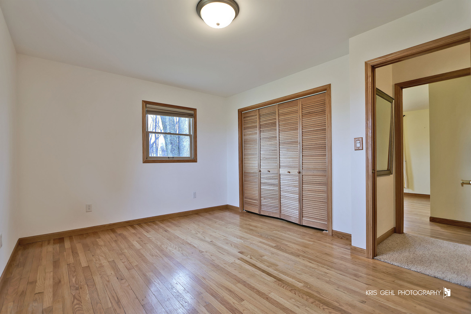 3409 Chukar Road Woodstock, IL 60098 - Photo 7 of 15 an empty room with wooden floor and windows