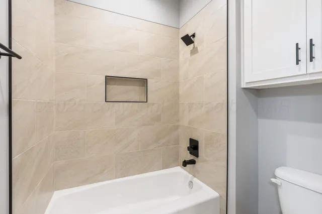 a bathroom with a shower and a toilet
