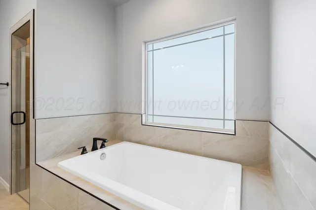 a white bath tub sitting next to a white sink