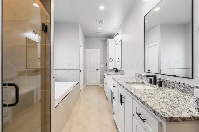 a bathroom with a granite countertop sink mirror and double