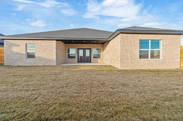 a view of house with backyard and window