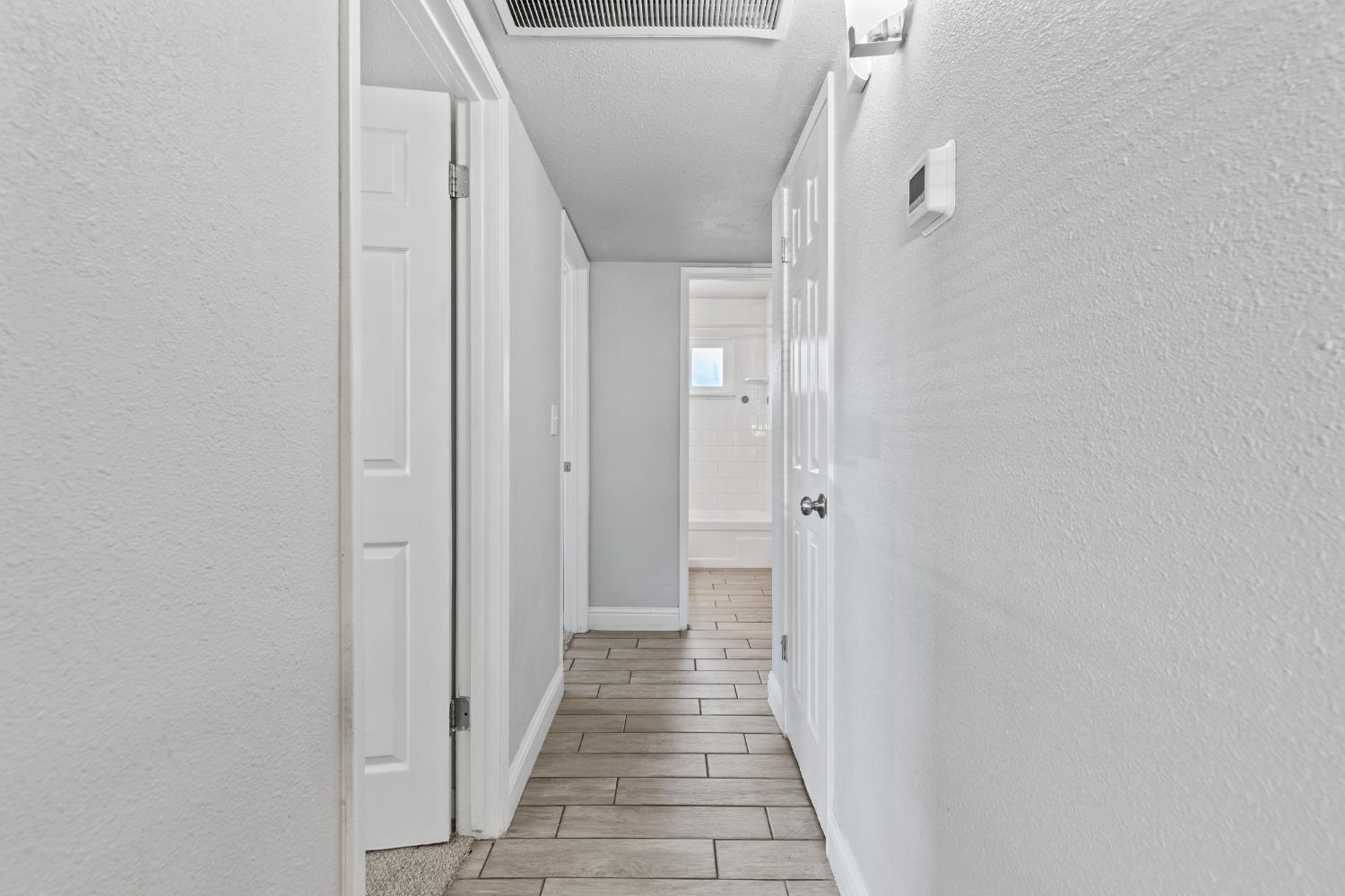 2525 Orwell Court Modesto, CA 95354 - Photo 16 of 33 a view of a hallway with wooden floor and staircase
