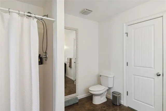 a view of a bedroom with a bed and the window