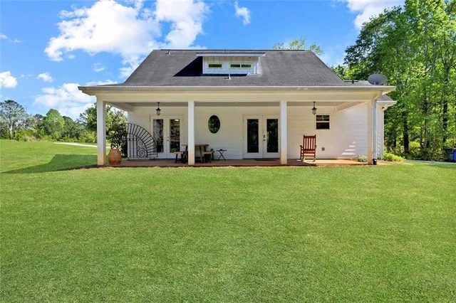 a front view of a house with a garden