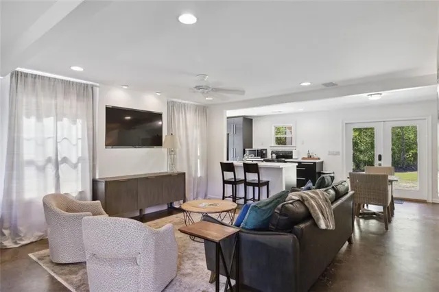 a living room with furniture and wooden floor