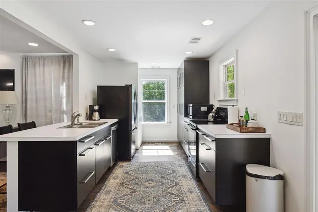 a metallic refrigerator freezer sitting in a kitchen