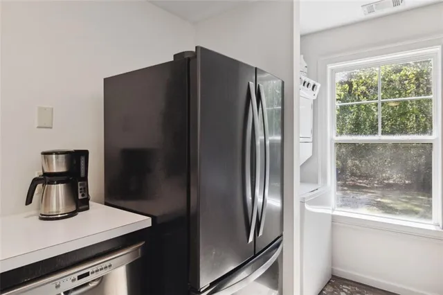 a kitchen with sink stove and refrigerator