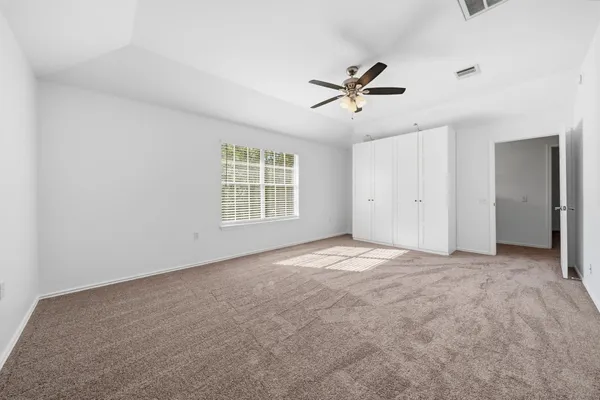 a view of a livingroom with a ceiling fan and window