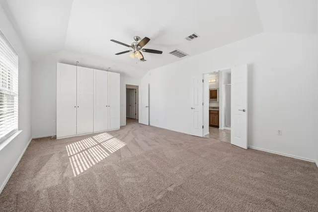 a view of a livingroom with a ceiling fan and window