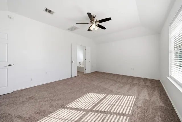 a view of empty room with ceiling fan