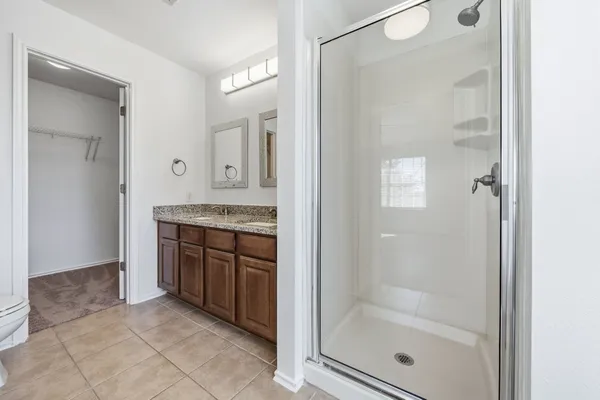 a white bath tub sitting next to a shower