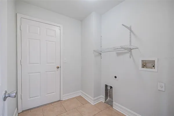 an empty room with closet and a ceiling fan