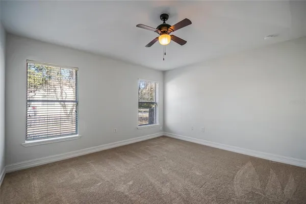 a bathroom with a tub a sink and mirror