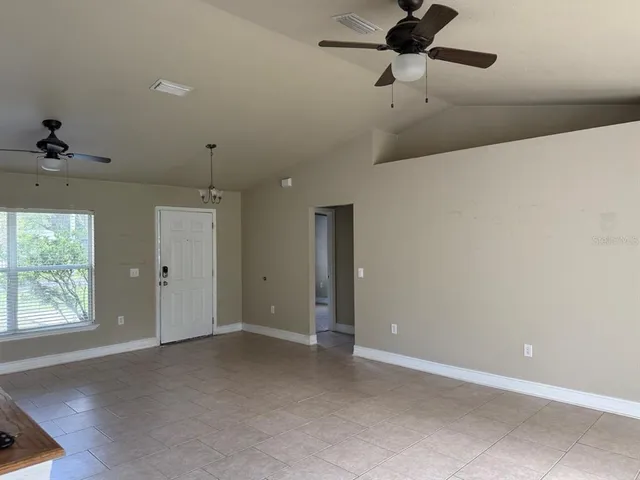 a view of a livingroom with a ceiling fan and window