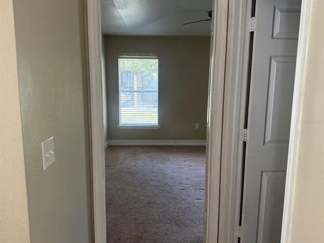 a view of an empty room with a closet