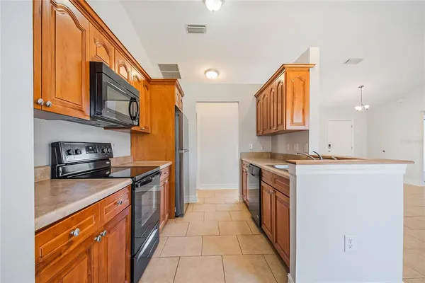 a kitchen with a refrigerator and a stove
