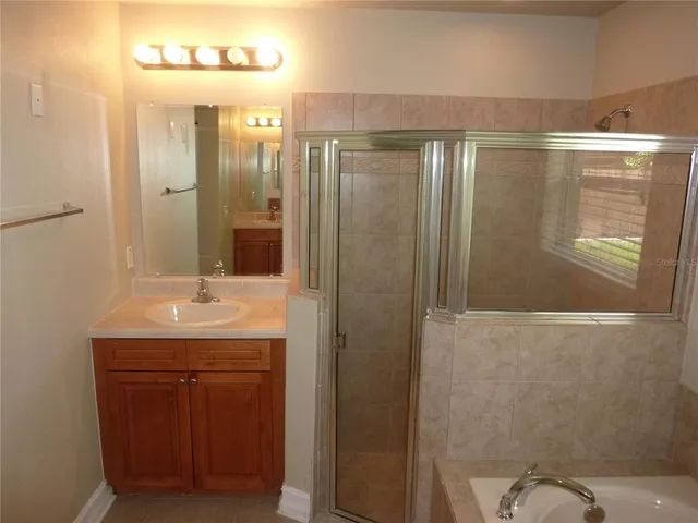 a bathroom with a shower and a sink