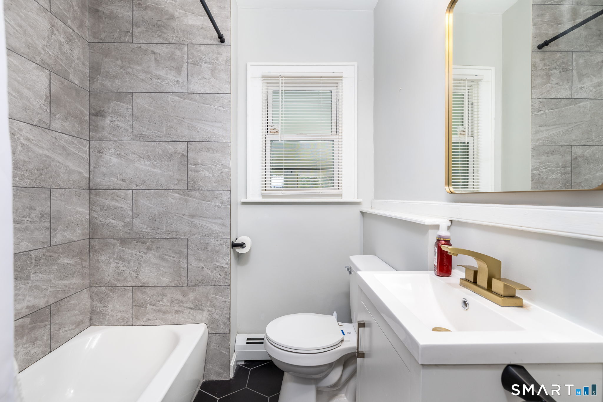 681 Main Street Cromwell, CT 06416 - Photo 14 of 39 a bathroom with a sink a toilet and a bathtub