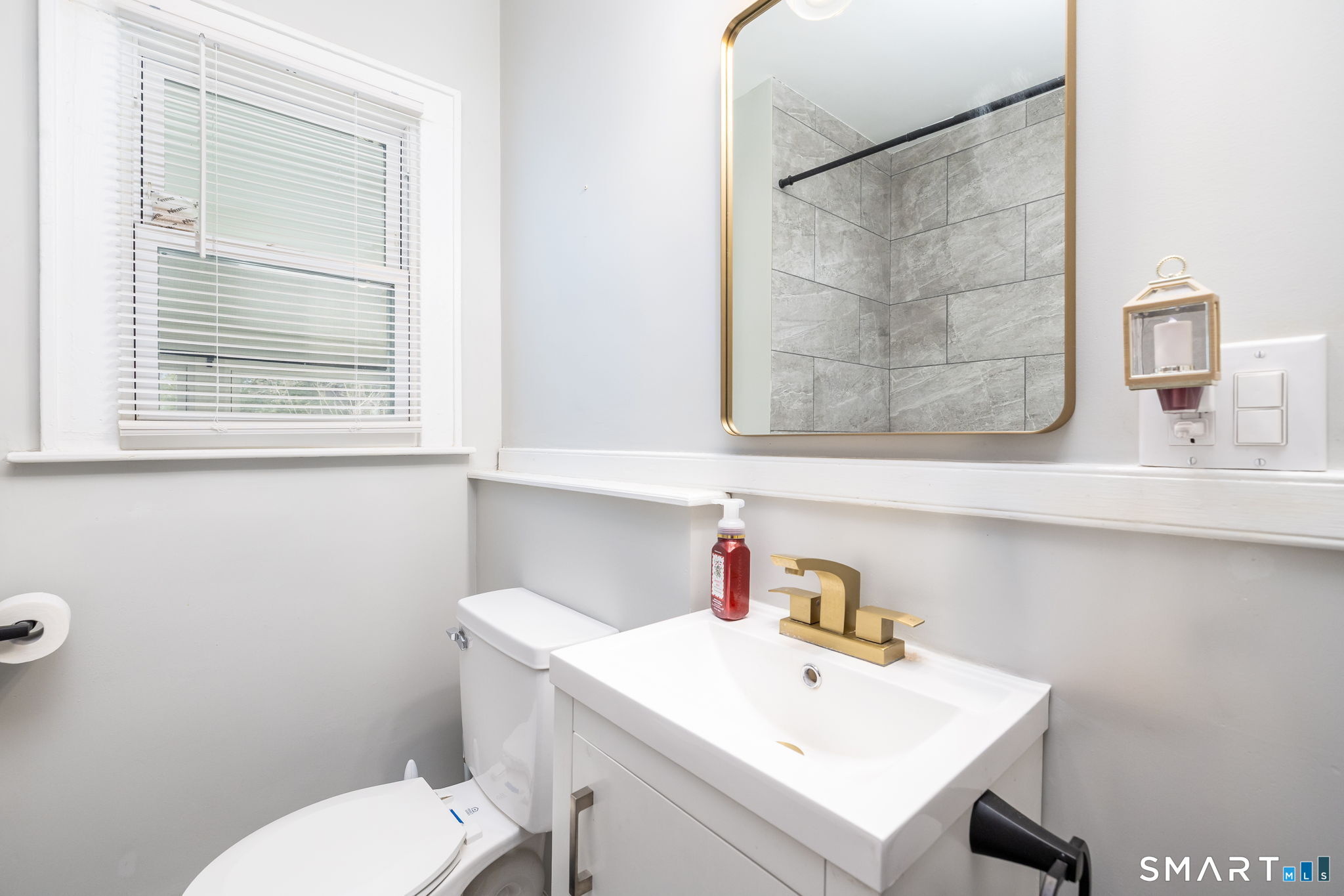 681 Main Street Cromwell, CT 06416 - Photo 15 of 39 a bathroom with a sink a toilet and a window