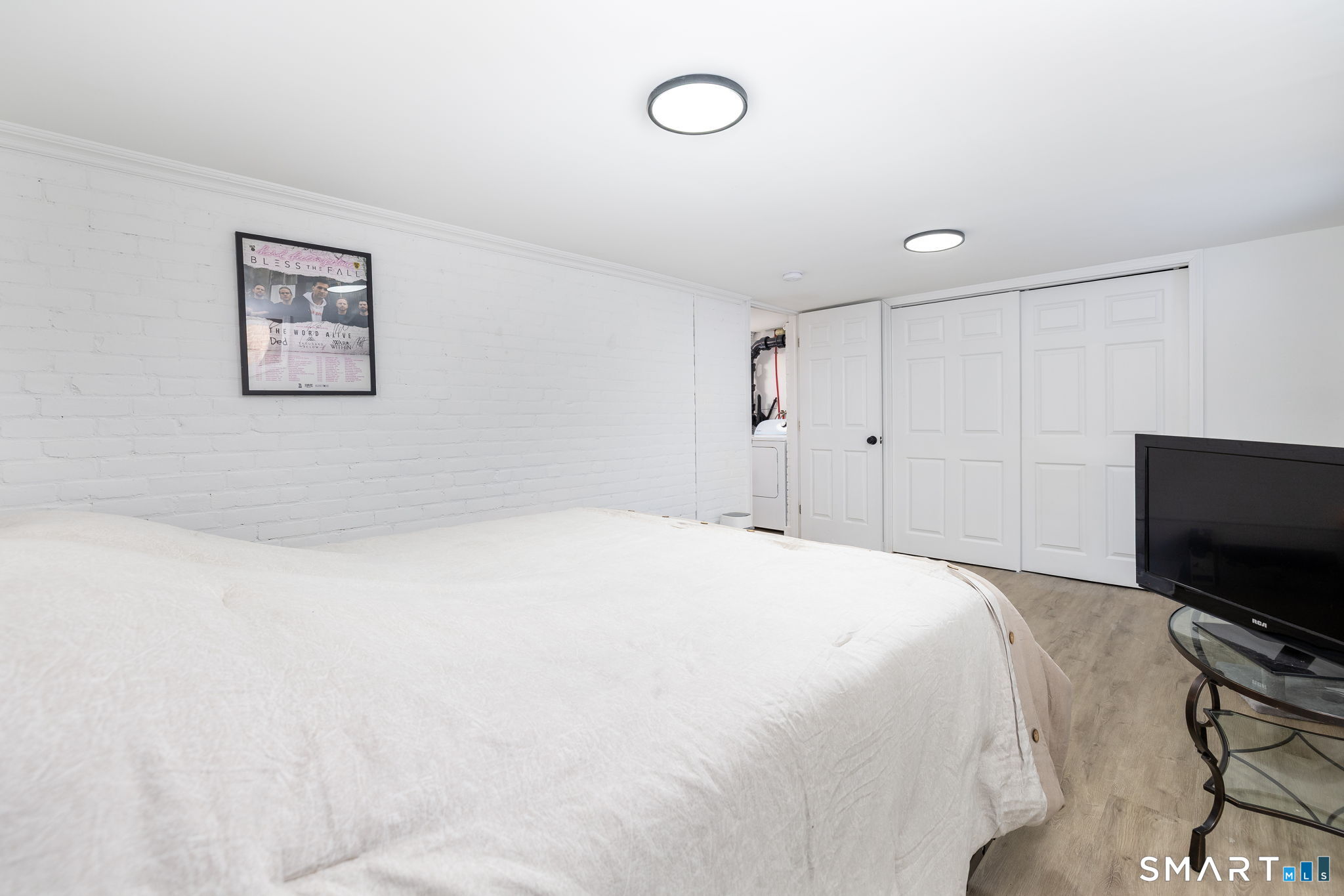 681 Main Street Cromwell, CT 06416 - Photo 25 of 39 a bedroom with a bed and a flat screen tv