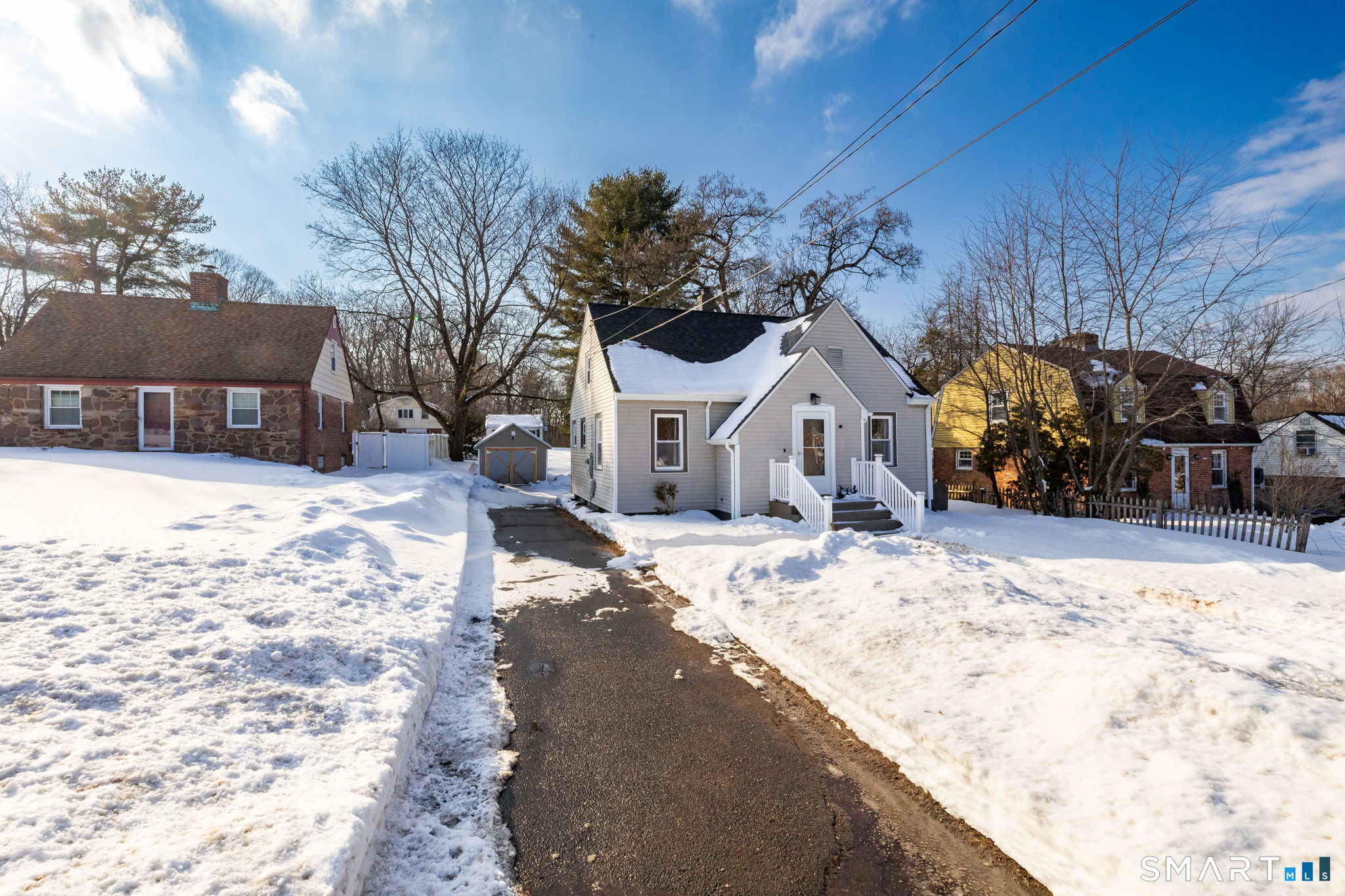 681 Main Street Cromwell, CT 06416 - Photo 28 of 39 a view of a white house covered in snow