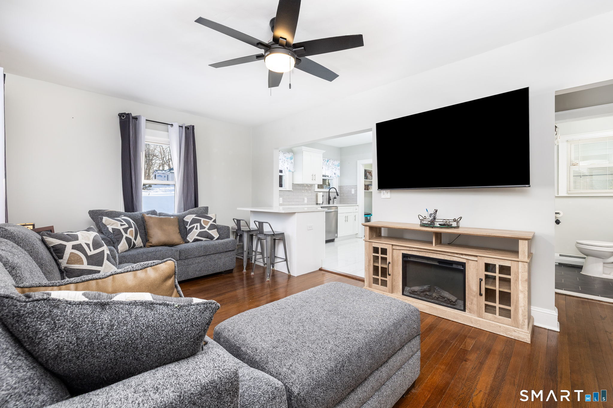 681 Main Street Cromwell, CT 06416 - Photo 3 of 39 a living room with fireplace furniture and a flat screen tv