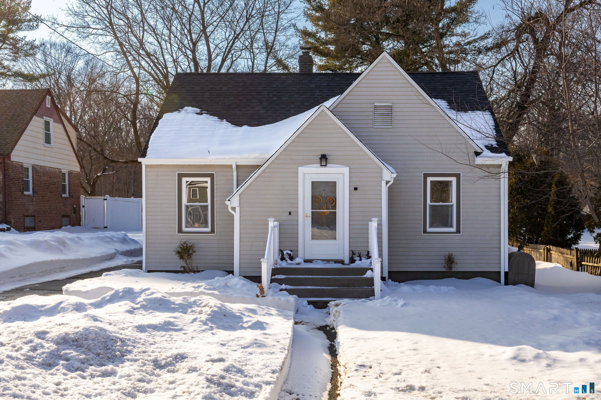 681 Main Street Cromwell, CT 06416 - Photo 33 of 39 a view of a house with a yard covered in snow