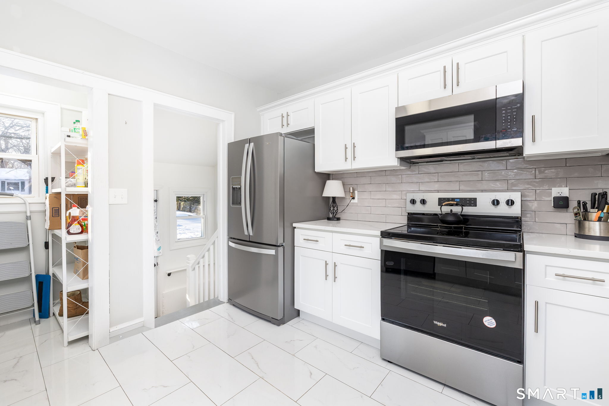 681 Main Street Cromwell, CT 06416 - Photo 36 of 39 a kitchen with stainless steel appliances granite countertop a refrigerator and a stove top oven