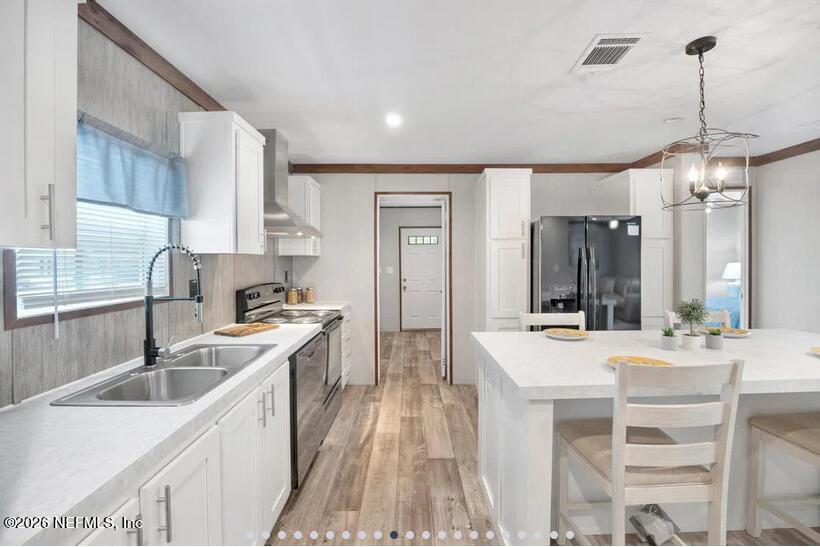 140 Islander Road Satsuma, FL 32189 - Photo 5 of 11 a kitchen with granite countertop a sink stove and refrigerator