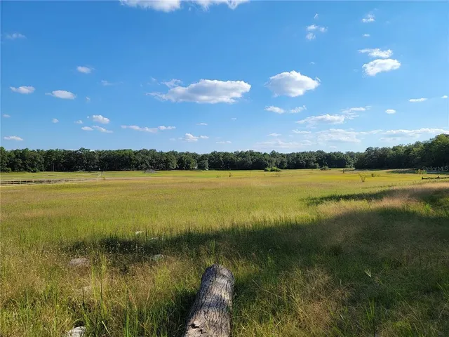 a view of lake with sunset in background