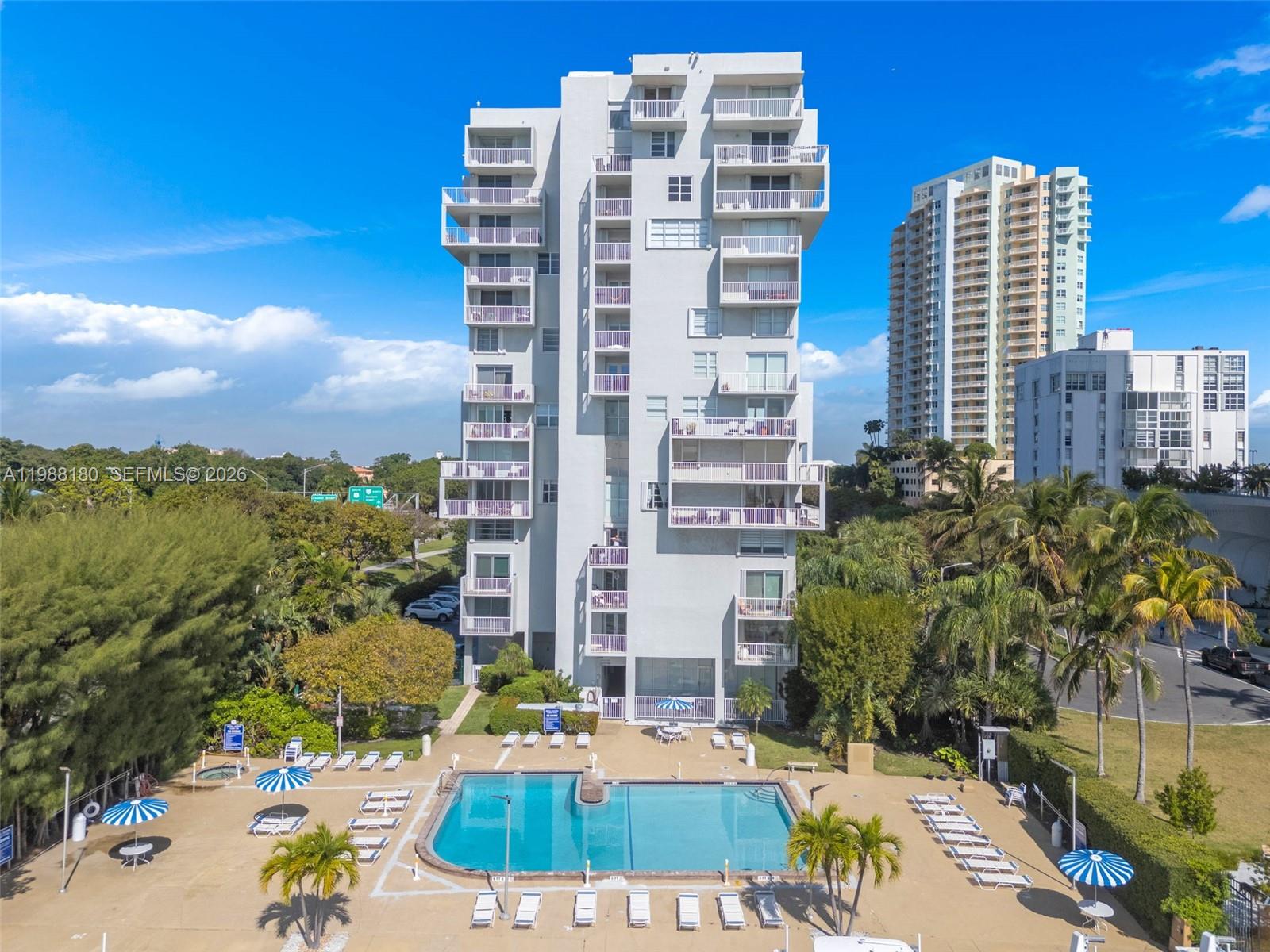 150 Southeast 25th Road, Unit 8H Miami, FL 33129 - Photo 2 of 41 a view of building with yard and staircase