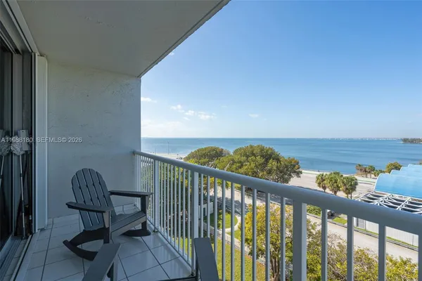 a view of a balcony with chair and table
