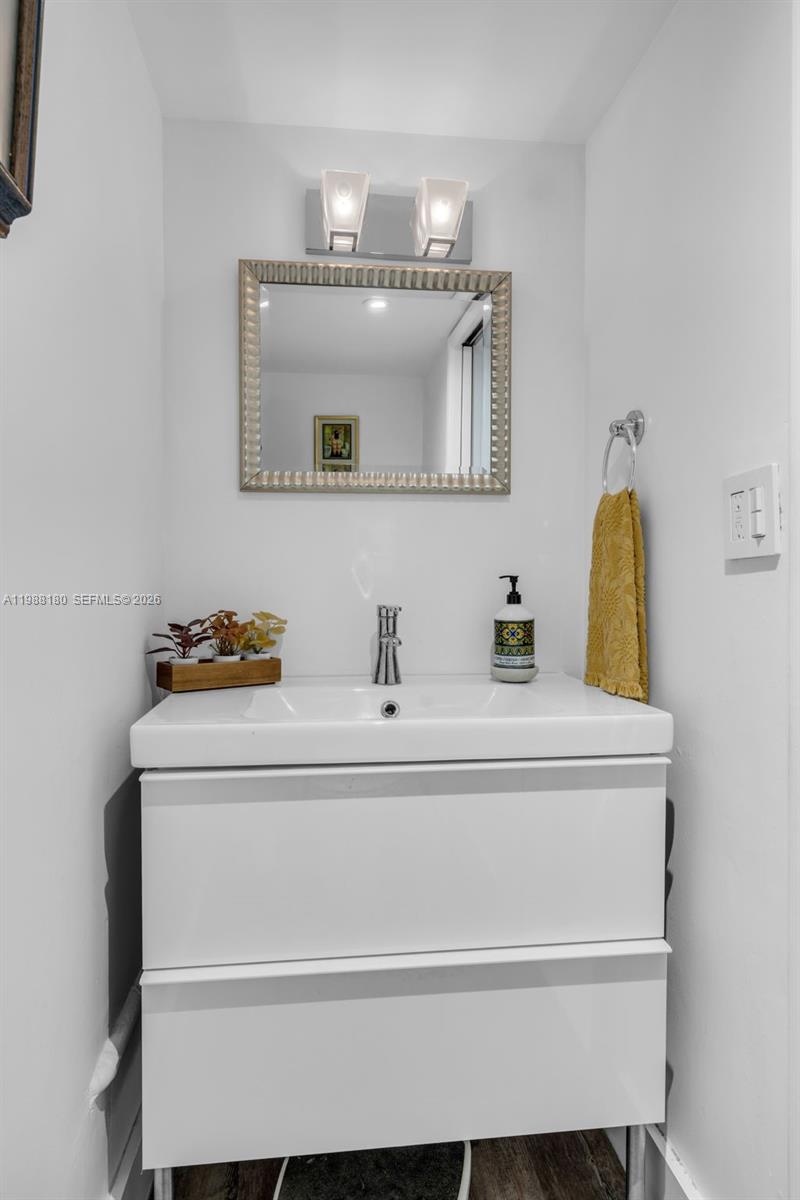 150 Southeast 25th Road, Unit 8H Miami, FL 33129 - Photo 23 of 41 a bathroom with a sink and a mirror