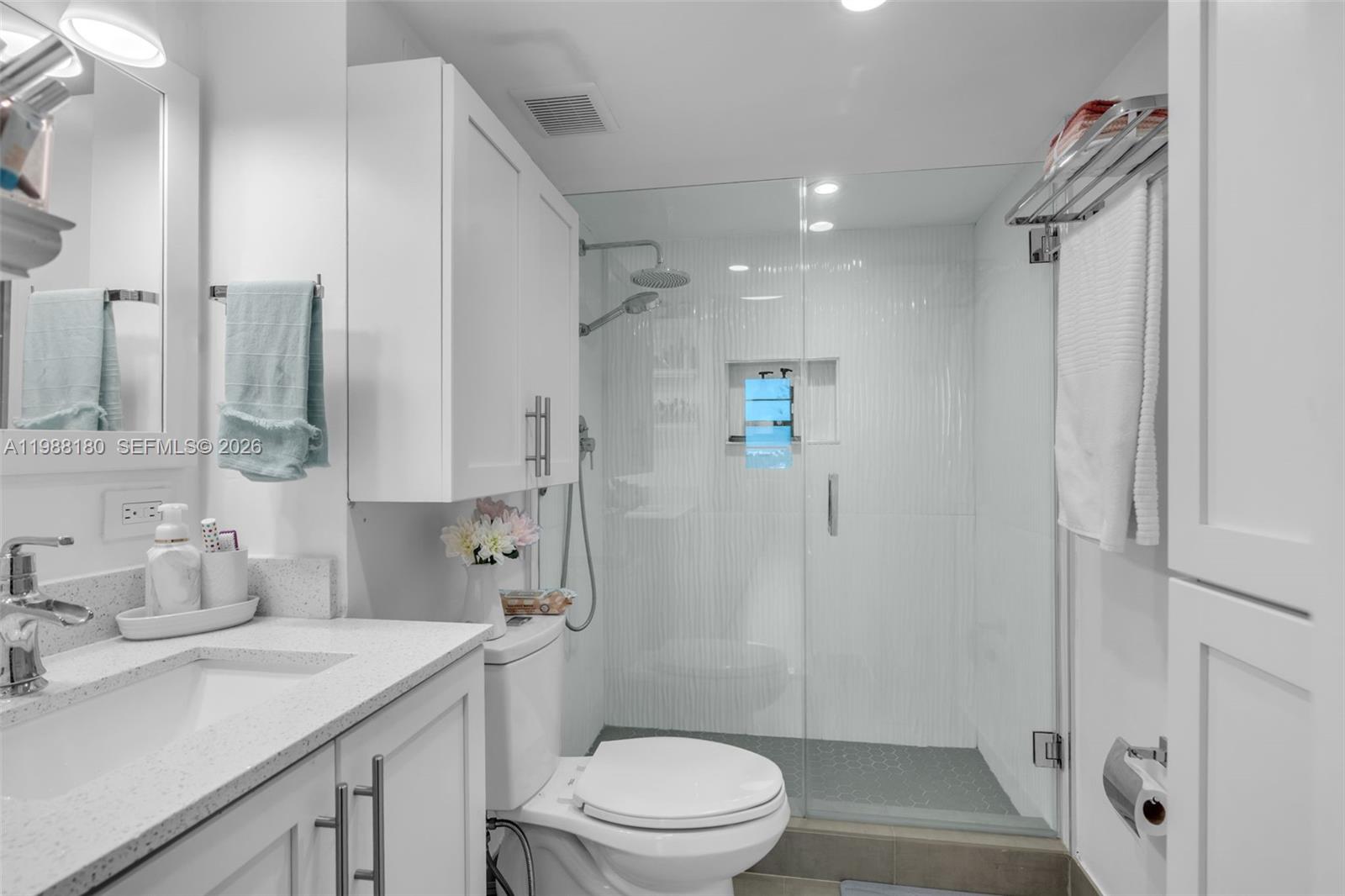 150 Southeast 25th Road, Unit 8H Miami, FL 33129 - Photo 24 of 41 a bathroom with a sink a toilet and shower