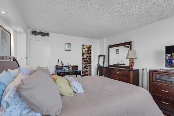 a bedroom with a bed and dresser