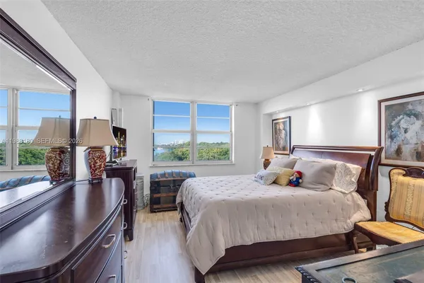 a bed room with a bed and large window