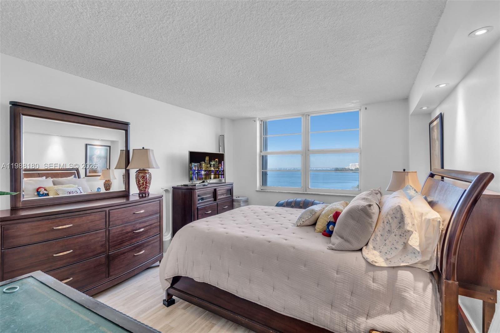 150 Southeast 25th Road, Unit 8H Miami, FL 33129 - Photo 28 of 41 a bedroom with a bed and a large mirror on the dresser