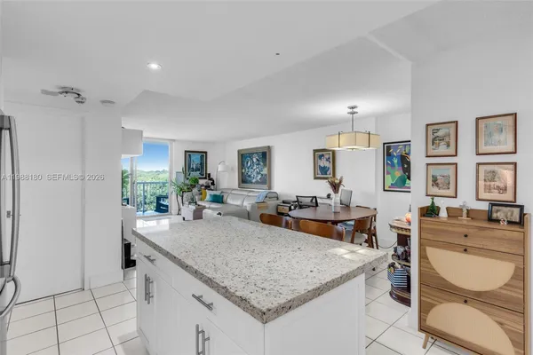 a kitchen with granite countertop a refrigerator and a sink