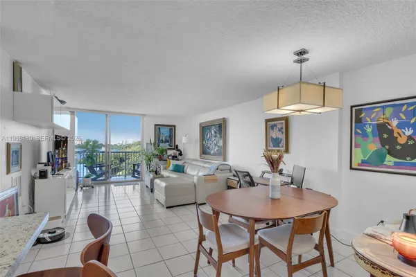 a living room with stainless steel appliances kitchen island granite countertop furniture and a kitchen view