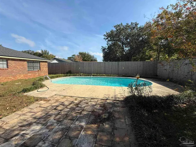 a view of a backyard with a small pool