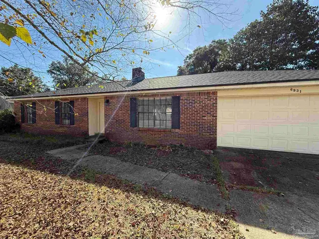 a view of a backyard with large trees